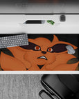 Orange fox fury on anime desk pad 36x16 inches, dramatic black shadows and sleek gray background mood.