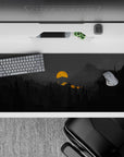36x16 inches mouse pad with moody mountain landscape, deep grays, glowing orange sun, and silhouetted pines for a bold and mysterious design.