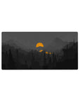 Mouse pad featuring moody mountain landscape, 32x16 inches, with silhouetted pines, deep grays, and glowing orange sun for an atmospheric vibe.