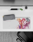 Soft pink anime desk mat mouse pad 28x12 inches, peach and crimson hair, petal flecks, cozy mood.