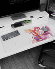 Anime desk pad 36x16 inches showing peach-haired girl with braid beside red-haired pianist in pale dress.