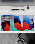 Energetic 32x16 desk mat combines bold hues and dynamic swirls for impactful yet stylish visuals