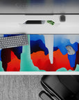 Striking 36x16 desk pad highlights bold blue, red, and green tones with intricate swirling details in stunning artistry