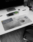 Large 32x16 inch desk mouse pad with smoky gray cloud design, faint stars, and soft planetary details.