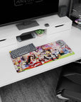 28x12 inches anime girl mouse pad with red-white shrine maiden lounging as friends snack in frilly hats.