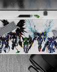 Black, green, and steel-gray mecha desk pad with icy blue wing flares, 40x20 inches.