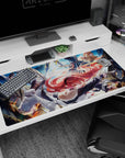 40x20 inches anime desk pad showing red-haired swordsman lunging at green-haired warrior gripping rope on rocks.