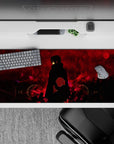 36x16 inches desk pad showcasing Itachi Uchiha in his Akatsuki cloak, with red skies and black ravens, exuding intensity and mystery.