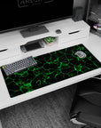 Artistic 36x16 inches desk pad showcasing bold green geometric patterns against a dark background, perfect for adding intensity and modern style to your desk.