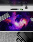 Deep violet and lilac desk pad with warm orange nebula glow, calm late-night vibe, 40x20 inches.