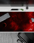 Moody wine-red space desk pad 40x20 inches with warm smoky tones fading to near-black, cinematic vibe.