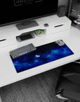 Half-lit moon in swirling sapphire clouds mouse pad 28x12 inches with tiny glitter-like stars.