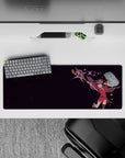 Megumin from Konosuba in mid-air with staff, 32x12 inch anime mouse pad, plum stars, energy spark in corner.