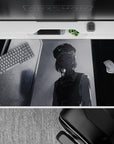 Eerie 40x20 desk pad featuring a ghostly figure with a red gaze in monochrome tones, perfect for fans of unsettling and atmospheric anime designs