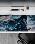Anime desk pad featuring a mysterious Demon Slayer character with teal hair and glowing butterflies, size 36x16 inches.