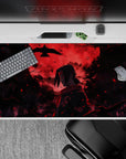 Anime mouse pad 40x20 inches featuring Itachi Uchiha from Naruto with a blood-red moon and crows, evoking tragedy and power.
