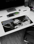 Wide-eyed anime girl with sharp-toothed grin and smoky ribbon shadows on a 32x16 inches desk mouse pad.