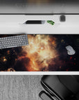 Moody 36x16 inches desk pad in smoky black with warm amber sparks and honey-gold glow, cosmic vibe.
