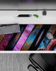Midnight black desk pad, 36x16 inches, in dreamy blues and hot pink nebula clouds, calm cosmic vibe.