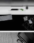 36x16 inches dark otaku desk pad in black and white with neon-red eyes, gritty street-note mood.
