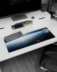 Above-the-clouds sunrise sky scene mouse pad, 32x12 inches, with tiny corner space station.