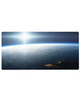 Space sunrise horizon desk mouse pad, calm clouds and tiny station silhouette, 32x16 inches.