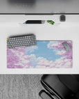 Compact 28x12 desk mat highlights cherry blossoms and blue sky for immersive peaceful vibes