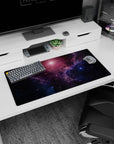 Dreamy star-speckled galaxy scene mouse pad, 32x16 inches, with swirling nebula haze across the desk.