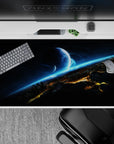 Moody sci-fi desk pad 40x20 inches in inky black, smoky gray, and electric cyan for calm deep-space vibes.