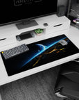 Blue planet over glowing horizon desk pad 36x16 inches with tiny stars and shattered skyline.