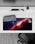 Cosmic desk mouse pad 28x12 inches in deep blue and rosy magenta tones with a warm sunrise-like core.