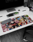 Natsu grinning with goggles and pink scarf beside Lucy in red chair, anime desk pad 36x16 inches.