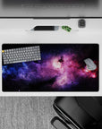 Moody space mouse pad 32x16 inches in dark backdrop with violet haze, electric blue and magenta glow.