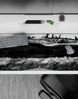 36x16 inches anime desk pad in ink-black shadows and bright steel highlights, moody high-contrast city scene.