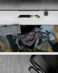 Chaotic-cute anime desk pad 36x16 inches in smoky gray-blue with warm sparks and glowing amber eyes.