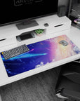 Comet and twinkling stars desk pad 36x16 inches over a blue-to-violet sky with peach edge.