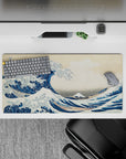 Dynamic 32x16 desk mat combines towering wave, serene mountain, and delicate boats for impactful visuals