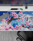 Tranquil 40x20 desk pad showcases sakura blossoms with uplifting sky vibes for a refreshing workspace aesthetic