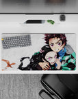 Tanjiro and Nezuko Demon Slayer anime mouse pad, 32x16 inches, featuring intense sibling bond and vibrant pink eyes.
