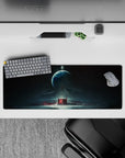 Moody teal and black mouse pad 32x12 inches with stormy haze, star specks, and glowing crimson core.