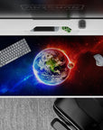Cosmic gradient desk pad 40x20 inches in deep blues fading to fiery reds with starry haze ambiance.