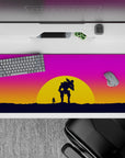 Vibrant 36x16 desk pad featuring a sunset battle scene with a lone figure and mech companion, set against pink, orange, and purple tones