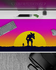 Bold 40x20 desk pad with a silhouetted figure and mech, set against a vibrant sunset of pink, orange, and purple, capturing adventure and solitude