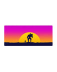 Sunset battle 28x12 mouse pad with a lone figure and mech silhouetted against vibrant pink, orange, and purple hues for an epic, futuristic feel