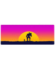 Sunset battle 32x12 mouse pad featuring a lone figure and mech silhouetted against vibrant sunset hues for a dynamic, futuristic workspace design