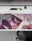 Nezuko from Demon Slayer on a 36x16 inch desk pad, surrounded by wisteria blossoms, capturing a serene and magical moment.