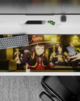 Megumin from Konosuba in a tavern scene on a 36x16 inch anime desk pad, exuding casual wizard energy and warm chaos.