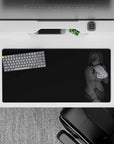 Moody grayscale anime girl mouse pad 32x16 inches with calm, teasing vibe and subtle blue eyes on black.