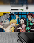 40x20 inches desk pad showcasing the Demon Slayer squad—Tanjiro, Nezuko, Zenitsu, and Inosuke—in vibrant poses and powerful colors.