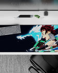 Tanjiro from Demon Slayer on 36x16 inch anime desk pad, showcasing a water dragon attack with vibrant colors and dynamic energy.